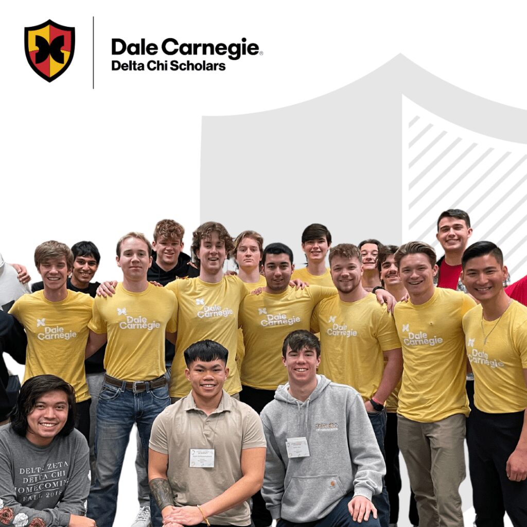 A group of young people smiling and wearing yellow and grey shirts.