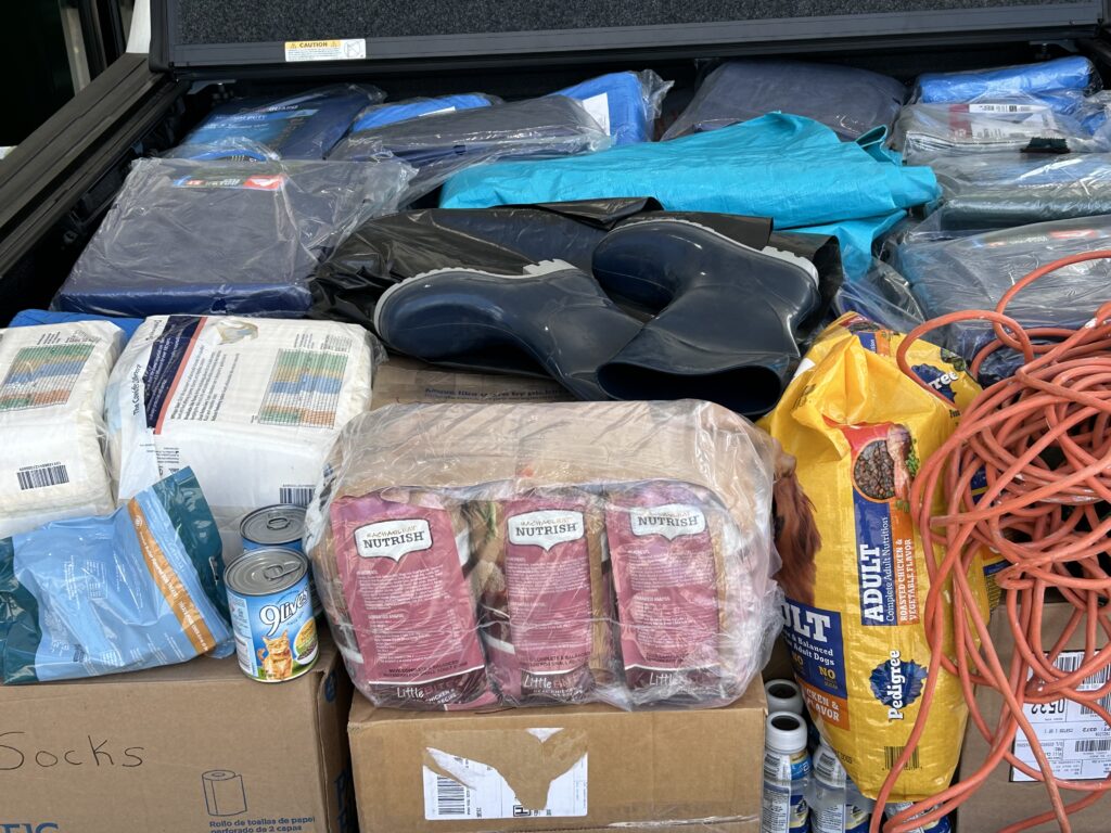 A variety of packaged food items stacked together on a surface.