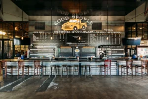 Brewery bar with stools and menu board.