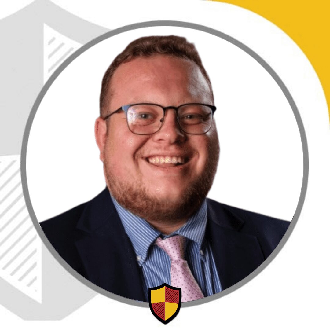 Smiling bearded man in suit and glasses